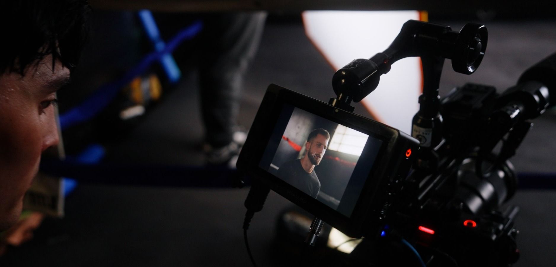 A director checks a fighter's frame on the camera monitor